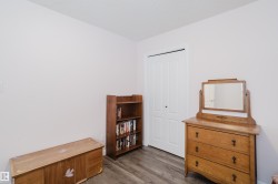 This room features light-colored walls and wood-look flooring - 
