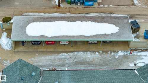 Covered parking area with visible vehicles and a pitched roof building - 25 9926 80 Avenue, Edmonton, AB - Outdoor