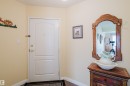 Entryway featuring a white door with brass hardware and a dark floor mat - 25 9926 80 Avenue, Edmonton, AB  - Indoor Photo Showing Other Room 