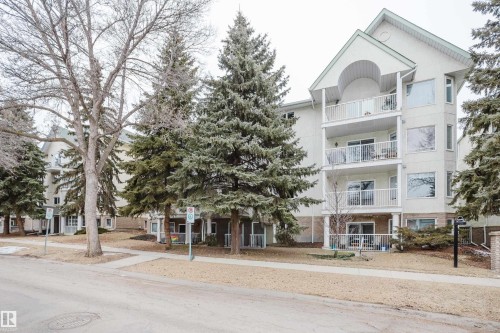 This property features a multi-story building with balconies and large windows - 25 9926 80 Avenue, Edmonton, AB - Outdoor With Balcony