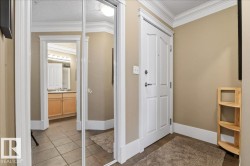 Mirrored closet doors with white trim and crown molding - 