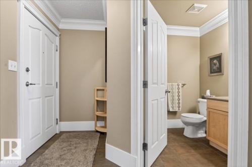 Entryway with crown molding and white trim - 701 9707 105 Street, Edmonton, AB - Indoor Photo Showing Bathroom