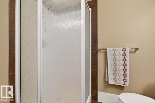 Frosted glass shower enclosure featuring white trim - 701 9707 105 Street, Edmonton, AB - Indoor Photo Showing Bathroom