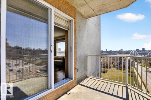 Private balcony featuring concrete flooring and a white metal railing - 701 9707 105 Street, Edmonton, AB - Outdoor With Balcony With Exterior