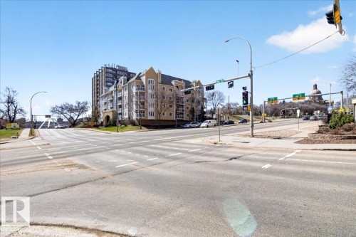 Low-rise building exterior featuring stucco cladding and multiple balconies - 701 9707 105 Street, Edmonton, AB - Outdoor