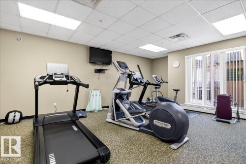 Dedicated fitness space featuring patterned carpet flooring and a neutral color palette - 701 9707 105 Street, Edmonton, AB - Indoor Photo Showing Gym Room