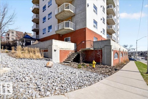 Multi-story building featuring a brick and concrete facade with multiple private balconies - 701 9707 105 Street, Edmonton, AB - Outdoor With Balcony
