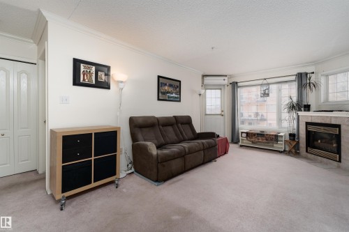 309 13450 114 Avenue, Edmonton, AB - Indoor Photo Showing Living Room With Fireplace