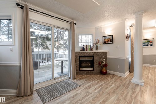 309 13450 114 Avenue, Edmonton, AB - Indoor Photo Showing Living Room With Fireplace