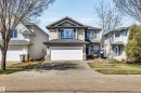 Two-story residence featuring light-toned siding, a dark shingle roof, and a prominent attached two-car garage - 96 Bonin Crescent, Beaumont, AB  - Outdoor With Facade 