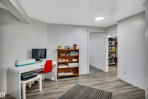 Versatile room featuring wood-finish flooring, light gray walls, and recessed ceiling lighting - 96 Bonin Crescent, Beaumont, AB - Indoor