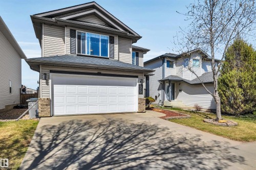 Two-story residence featuring light-colored siding and a dark shingle roof - 96 Bonin Crescent, Beaumont, AB - Outdoor