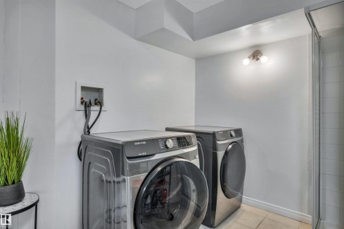 Dedicated laundry area featuring a washer and dryer hookup, recessed ceiling, and tiled flooring - 96 Bonin Crescent, Beaumont, AB - Indoor Photo Showing Laundry Room