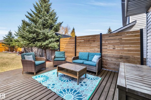 Hardwood deck with a horizontal plank privacy fence and extensive grassy yard - 96 Bonin Crescent, Beaumont, AB - Outdoor With Deck Patio Veranda With Exterior