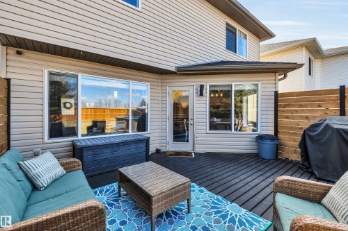 Spacious composite deck featuring horizontal privacy fencing and a walk-out door - 96 Bonin Crescent, Beaumont, AB - Outdoor With Deck Patio Veranda With Exterior