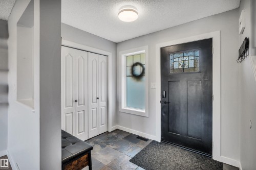 Entryway featuring slate-finish flooring and a contemporary overhead light fixture - 96 Bonin Crescent, Beaumont, AB - Indoor Photo Showing Other Room