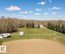 Expansive property with a large, level dirt arena - 