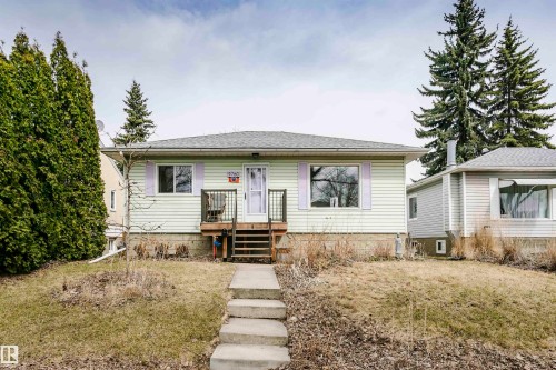 Single-story residence featuring light-colored siding and a grey shingle roof - 9760 64 Avenue, Edmonton, AB - Outdoor