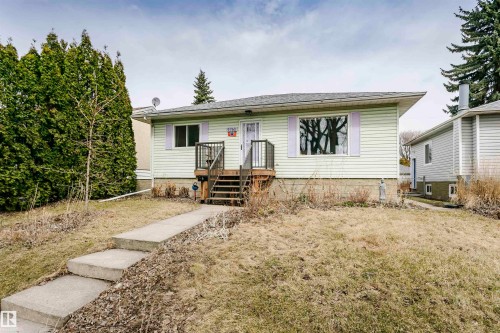 Single-story residence featuring light-colored siding and a dark shingle roof - 9760 64 Avenue, Edmonton, AB - Outdoor