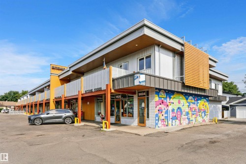 Contemporary commercial building featuring a multi-level design with a flat roofline, integrated retail storefronts, and an exterior mural - 9760 64 Avenue, Edmonton, AB - Outdoor