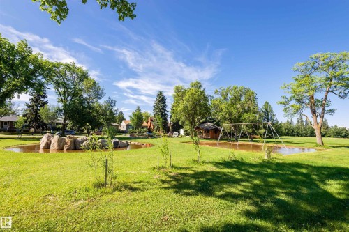 Expansive green lawn featuring two natural ponds and mature trees - 9760 64 Avenue, Edmonton, AB - Outdoor