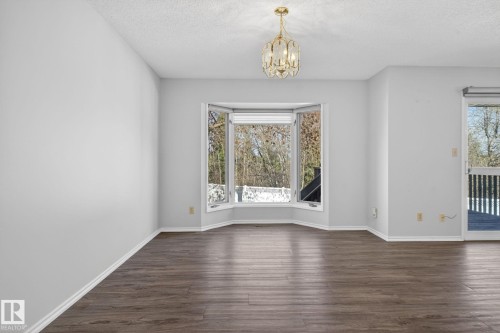 Spacious interior featuring wood-finish flooring and light-toned walls - 46 903 109 Street, Edmonton, AB - Indoor