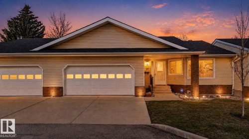Exterior featuring light-toned horizontal siding and a dark shingle roof - 46 903 109 Street, Edmonton, AB - Outdoor