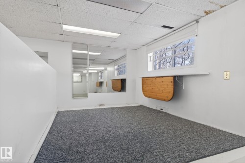 Room featuring gray carpeting, white walls, and a drop ceiling with integrated fluorescent lighting - 46 903 109 Street, Edmonton, AB - Indoor Photo Showing Other Room