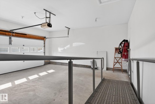 Spacious garage with a concrete floor, white walls, and an overhead garage door opener - 46 903 109 Street, Edmonton, AB - 