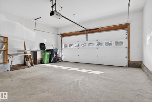 Spacious garage featuring a concrete floor, white interior walls, and an automatic overhead door - 46 903 109 Street, Edmonton, AB - Indoor Photo Showing Garage