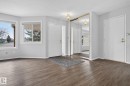 Entryway featuring wood-finish flooring, white trim, and a full-height mirrored closet - 46 903 109 Street, Edmonton, AB  - Indoor Photo Showing Other Room 