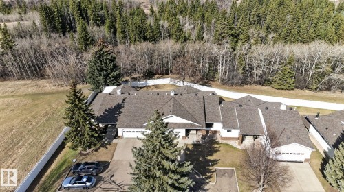 Substantial property featuring multiple structures and a backdrop of dense woodland - 46 903 109 Street, Edmonton, AB - Outdoor With View