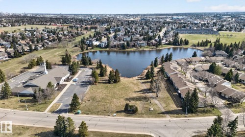 Sprawling residential area featuring a central lake and surrounding green spaces - 46 903 109 Street, Edmonton, AB - Outdoor With Body Of Water With View
