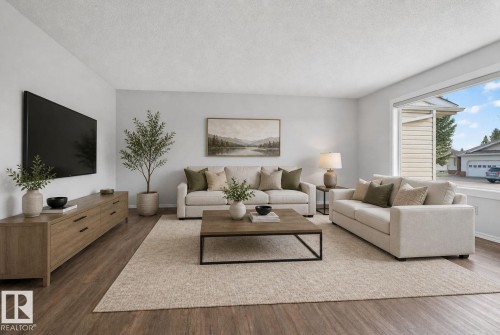 Spacious room featuring wood-finish flooring, light-colored walls, and a large window with white trim - 46 903 109 Street, Edmonton, AB - Indoor Photo Showing Living Room