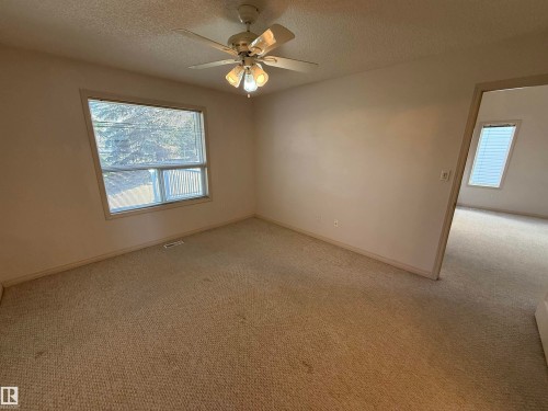 Neutral-toned carpeting throughout the room - 14 330 Galbraith Close, Edmonton, AB - Indoor Photo Showing Other Room
