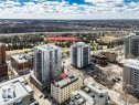 Aerial perspective of a multi-story residential building featuring a flat roof and a neutral-toned exterior - 403 10021 116 Street, Edmonton, AB  - Outdoor With View 