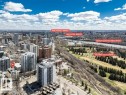 Aerial perspective showcasing a dense urban environment with a prominent river system and green spaces - 403 10021 116 Street, Edmonton, AB  - Outdoor With View 