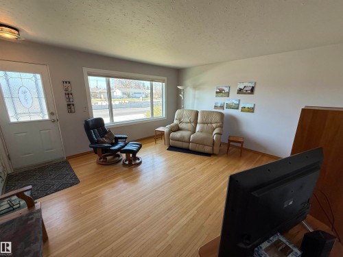 Living area with wood-finish flooring and light gray wall paint - 16112 87 Avenue, Edmonton, AB - Indoor