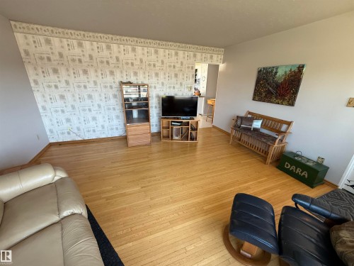 Hardwood flooring throughout a spacious room with light-colored walls - 16112 87 Avenue, Edmonton, AB - Indoor Photo Showing Living Room