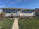 Ranch-style exterior with light-colored horizontal siding and a gray shingle roof - 16112 87 Avenue, Edmonton, AB  - Outdoor 