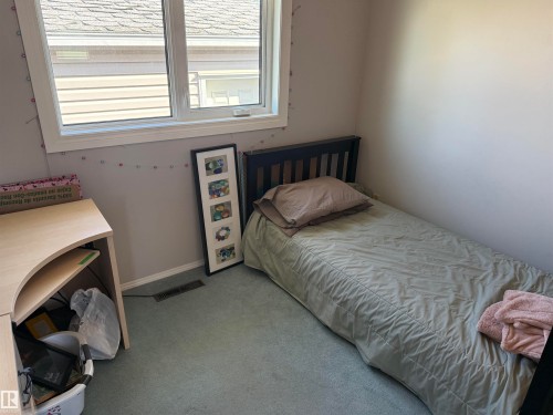 Light-filled room featuring a single window with white trim, wall-to-wall carpeting, and neutral wall tones - 16112 87 Avenue, Edmonton, AB - Indoor Photo Showing Bedroom