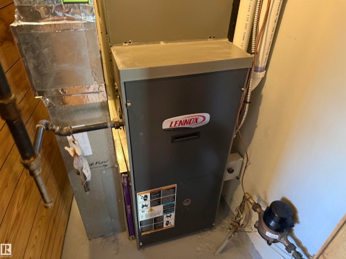Lennox HVAC system with visible ductwork, gas lines, and water meter - 16112 87 Avenue, Edmonton, AB - Indoor Photo Showing Basement