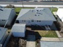 Residential property featuring a light-colored exterior, a gray shingle roof, and a detached storage shed with a matching shingle roof - 16112 87 Avenue, Edmonton, AB  - Outdoor 