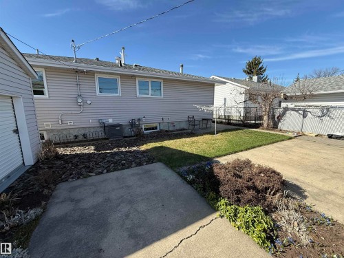 Rear exterior with light gray siding and white-framed windows - 16112 87 Avenue, Edmonton, AB - Outdoor