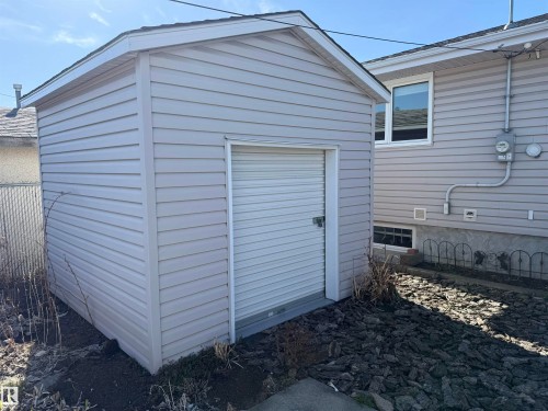 Detached shed with light-colored siding and a roll-up door - 16112 87 Avenue, Edmonton, AB - Outdoor