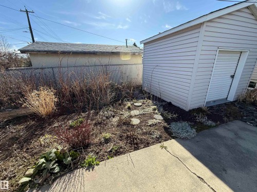 Detached storage shed with horizontal siding and a single access door - 16112 87 Avenue, Edmonton, AB - Outdoor