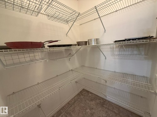 Pantry featuring white wire shelving, corner shelving, and integrated wire baskets - 5 2204 118 Street, Edmonton, AB - Indoor With Storage
