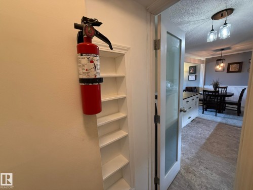 Built-in shelving unit with multiple tiers, offering practical storage - 5 2204 118 Street, Edmonton, AB - Indoor