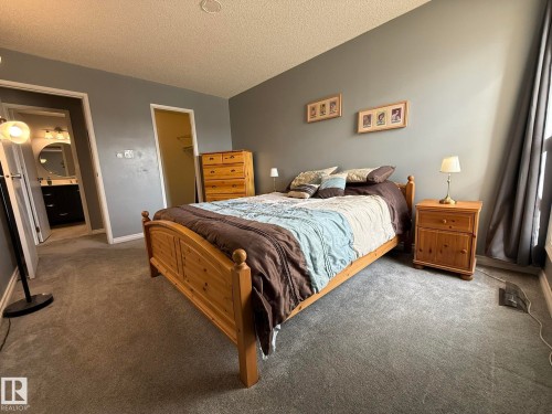 Carpeted room with a pale gray wall finish - 5 2204 118 Street, Edmonton, AB - Indoor Photo Showing Bedroom