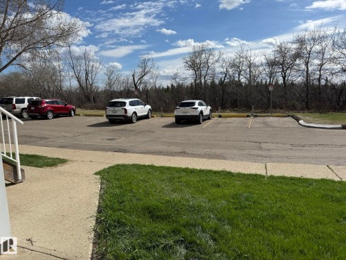 HERE IS A PHOTO OF YOUR #125 PARKING STALL WHERE THE WHITE SUV IS ON THE LEFT! - 5 2204 118 Street, Edmonton, AB - Outdoor
